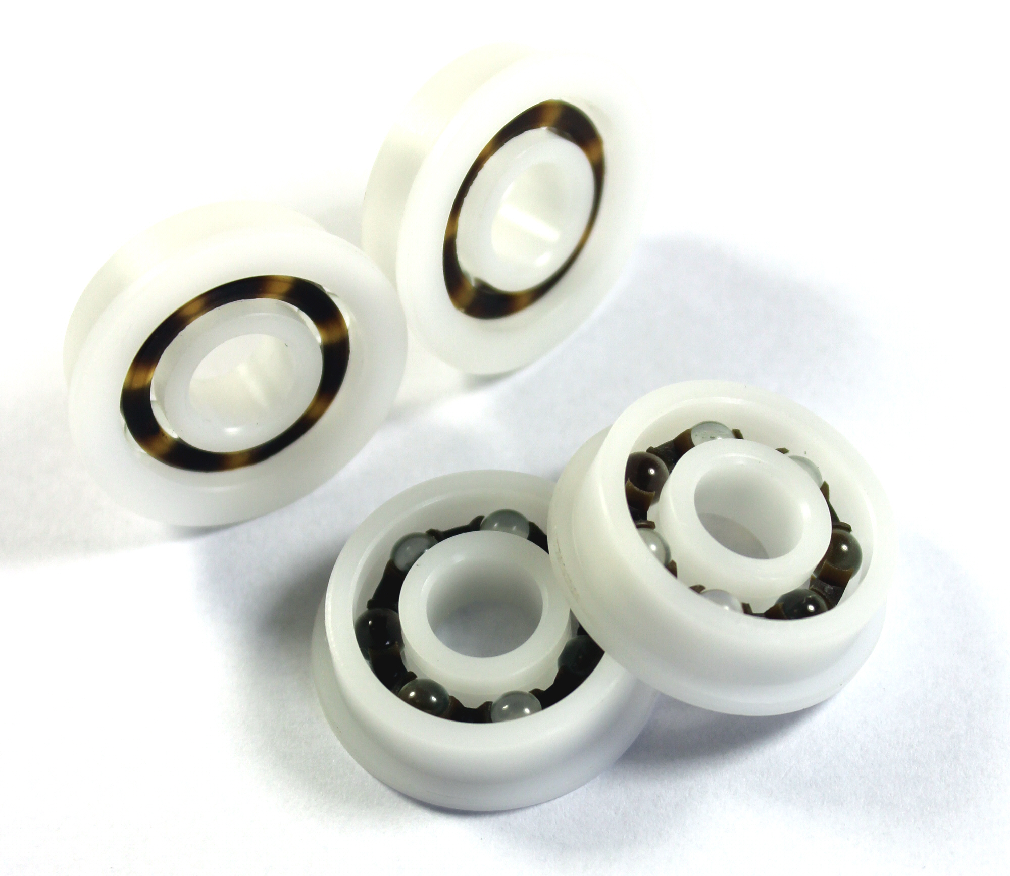 Plastic ball bearings are most commonly stocked with acetal resin (POM) rings and nylon (PA66) cages...